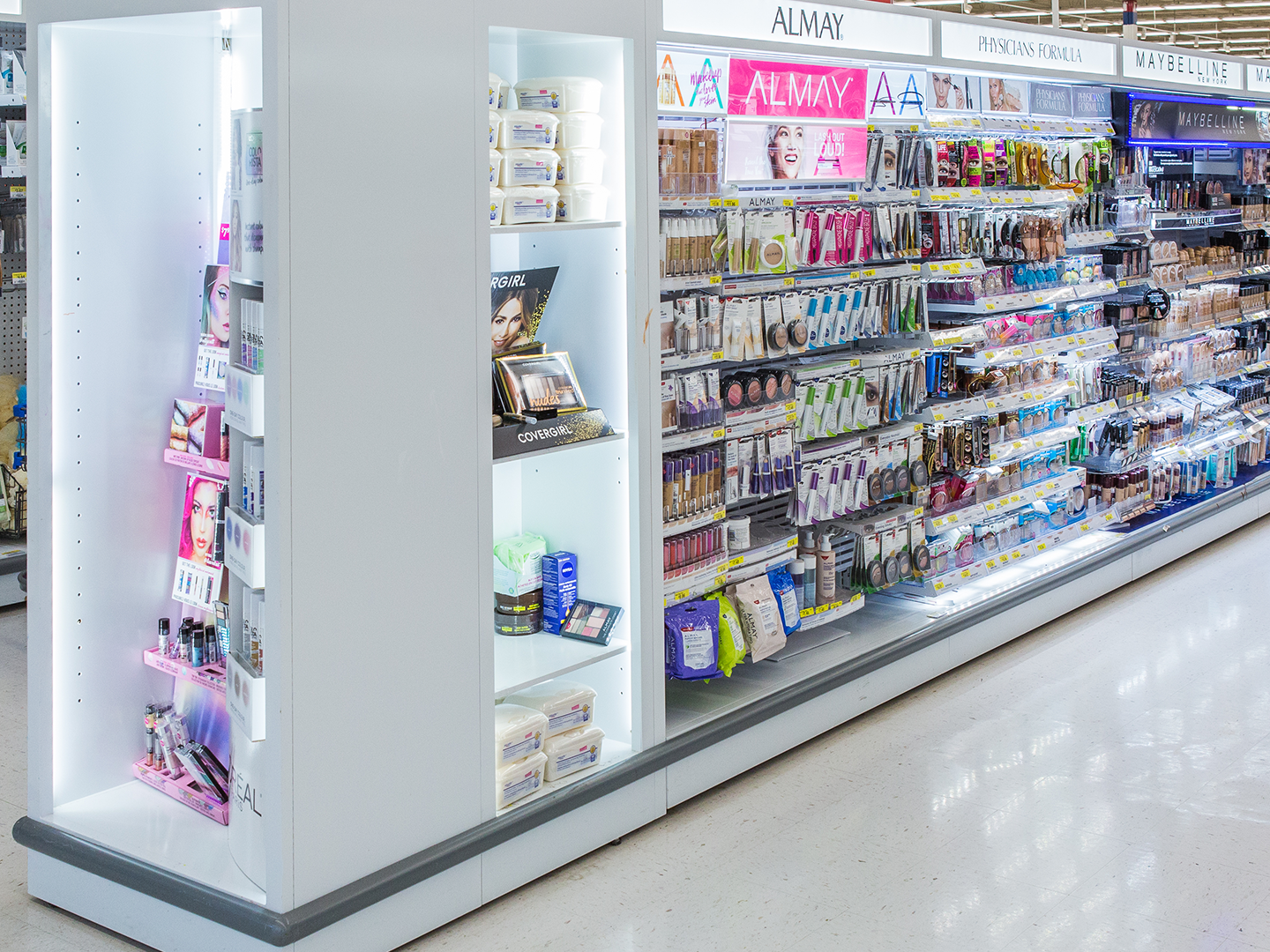 Focused shot of a custom cosmetic gondola with endcaps, showcasing organized shelves