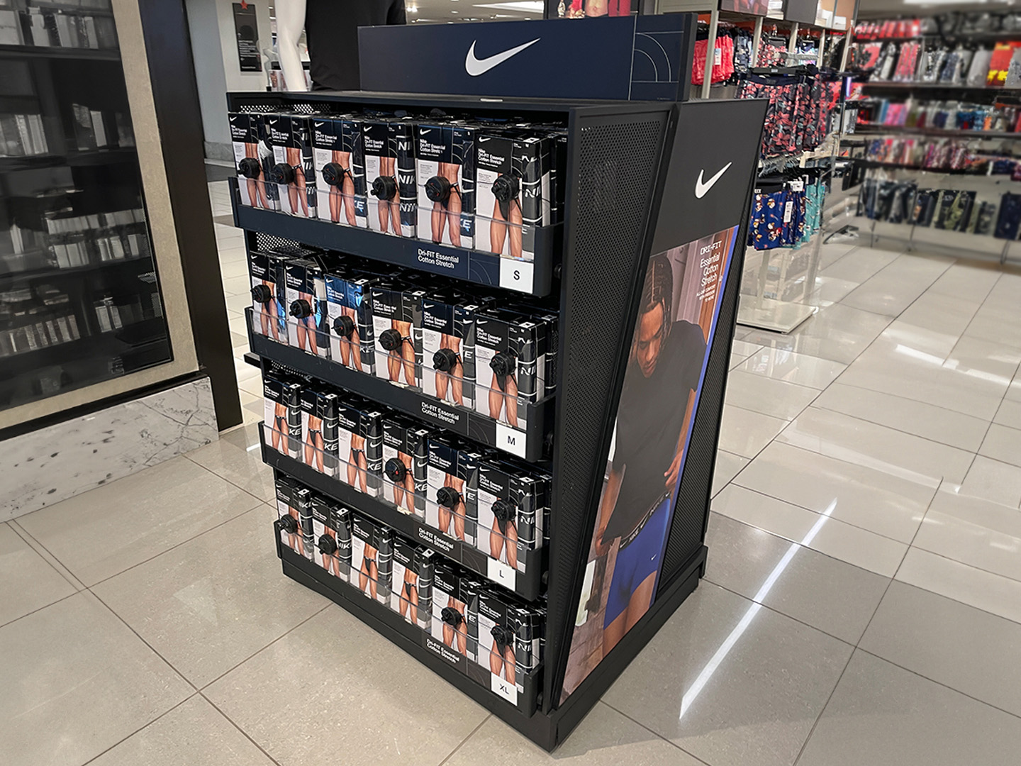 Custom underwear display with tiered shelving and sleek black frame